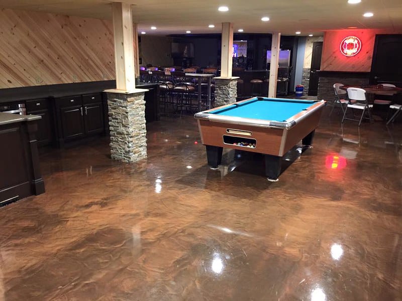 Image of a restaurant floor with a metallic marble epoxy flooring system. The flooring features a glossy, reflective surface with natural variations in color and texture, providing a unique and sophisticated look for any restaurant.